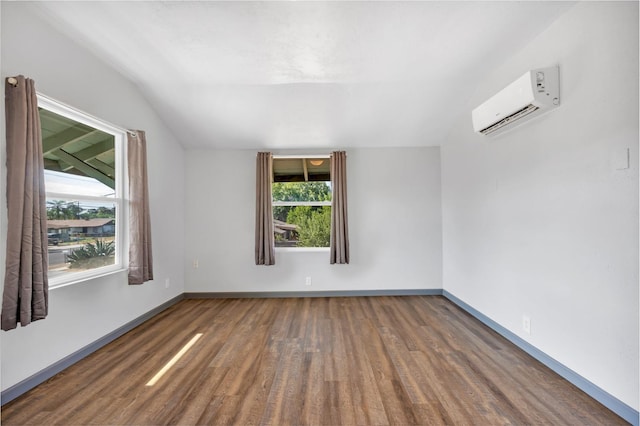 2567 S Rowell Ave, Fresno, CA 93725 - empty room featuring lofted ceiling, dark hardwood / wood-style floors, and an AC wall unit
