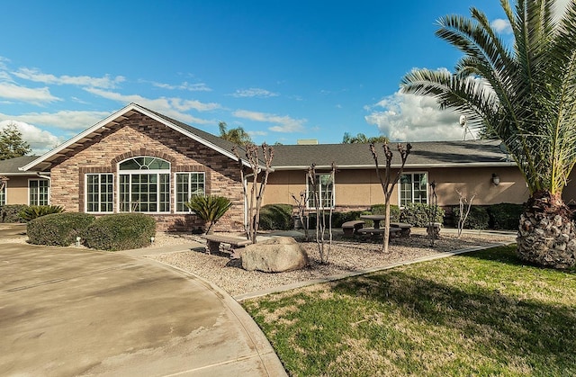 rear view of property featuring a lawn