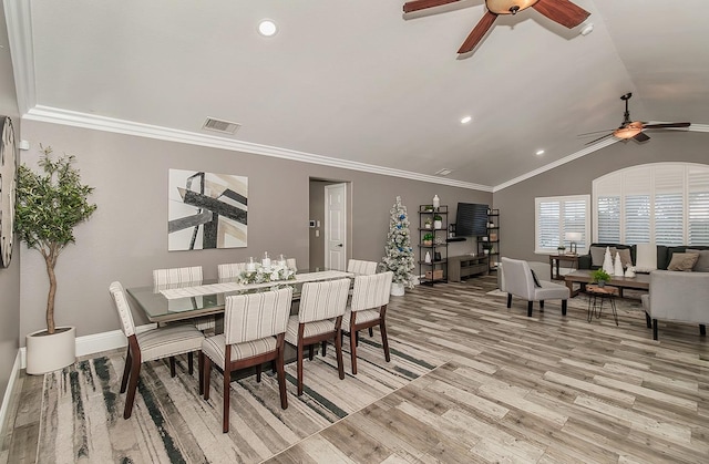 dining room with lofted ceiling, ornamental molding, light hardwood / wood-style floors, and ceiling fan