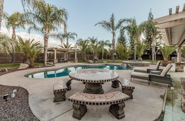 view of pool with an in ground hot tub, a pergola, and a patio