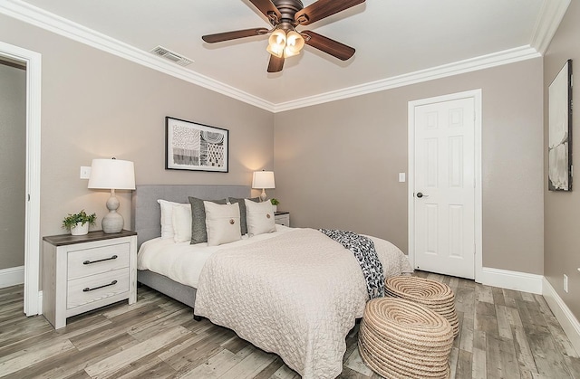 bedroom featuring ceiling fan, ornamental molding, and wood-type flooring