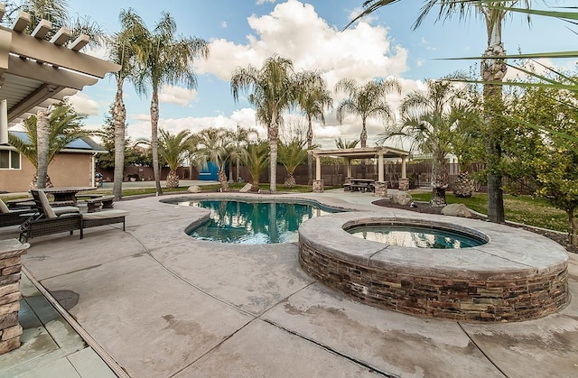 view of swimming pool featuring a gazebo, an in ground hot tub, and a patio area