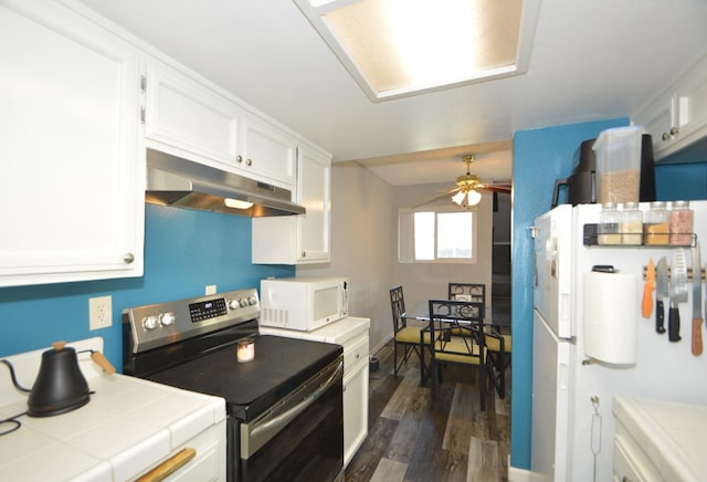 kitchen featuring white cabinetry, dark wood-type flooring, tile countertops, and white appliances