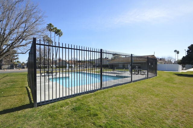 view of swimming pool featuring a lawn