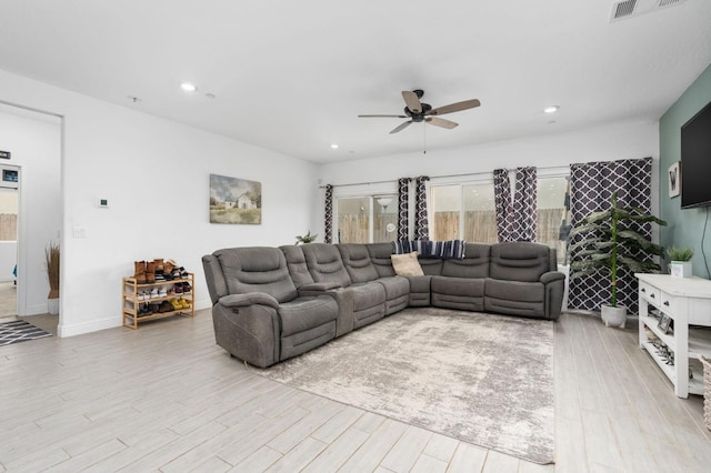 living room featuring ceiling fan and light wood-type flooring