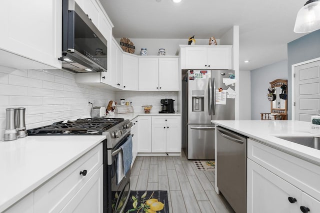 kitchen featuring white cabinetry, tasteful backsplash, and stainless steel appliances