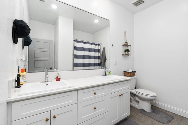 bathroom with a shower with shower curtain, vanity, toilet, and hardwood / wood-style floors