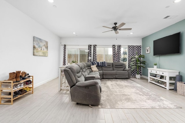 living room with ceiling fan and light hardwood / wood-style floors