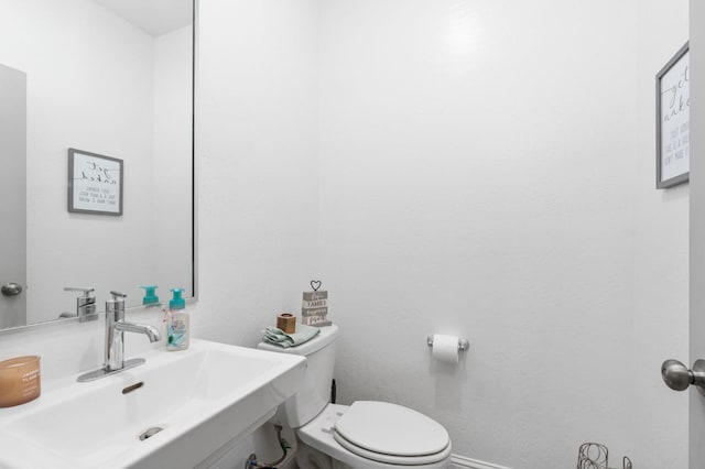 bathroom featuring sink and toilet