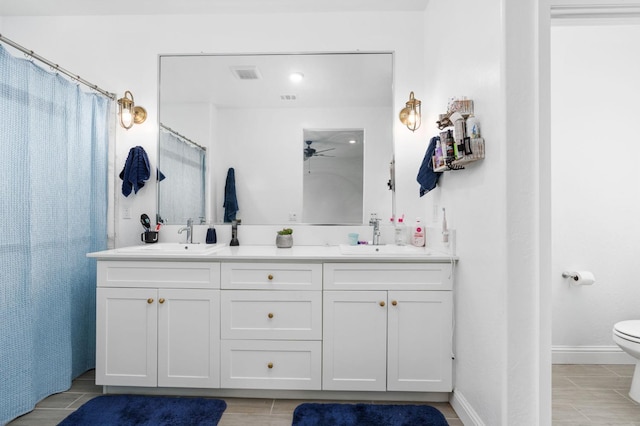 bathroom featuring ceiling fan, vanity, toilet, and curtained shower