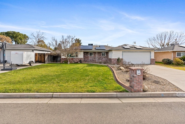 single story home featuring a garage, a front lawn, and solar panels