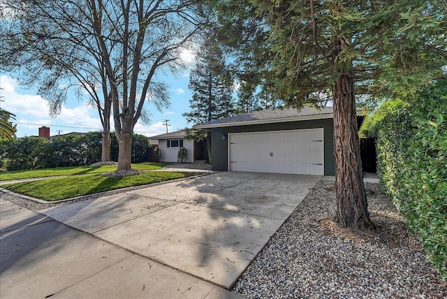 ranch-style home with a garage and a front lawn