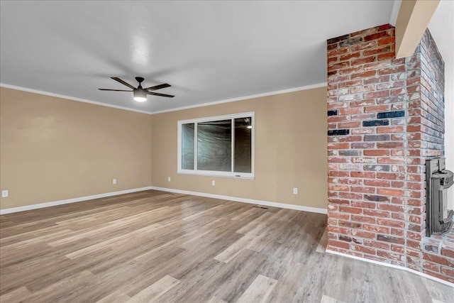 unfurnished living room with crown molding, ceiling fan, and light wood-type flooring