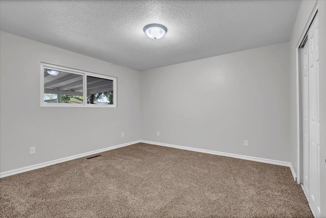 unfurnished bedroom with a closet, a textured ceiling, and carpet