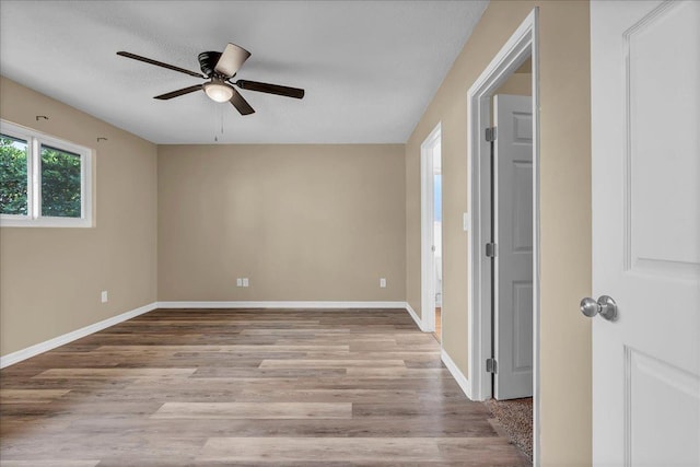 unfurnished room featuring a textured ceiling, ceiling fan, and light hardwood / wood-style flooring