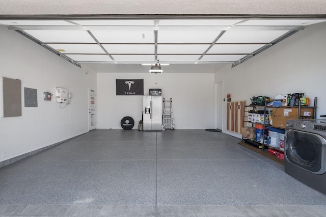 garage with washer / dryer, stainless steel fridge, electric panel, and a garage door opener