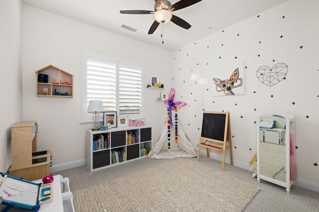 rec room featuring baseboards, a ceiling fan, visible vents, and carpet