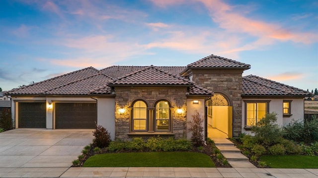 mediterranean / spanish-style home with a garage