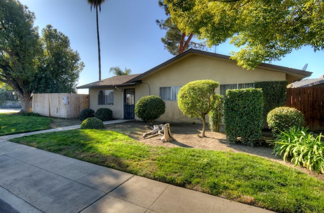 single story home featuring a front yard