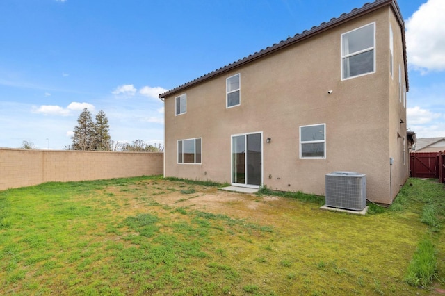 back of property featuring a yard and cooling unit