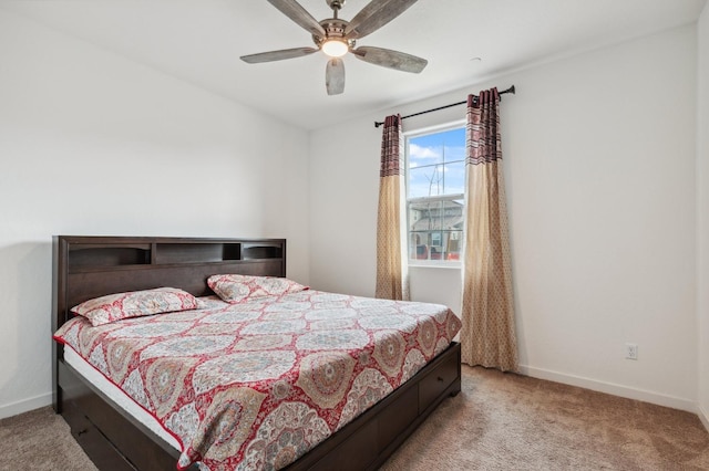 bedroom with ceiling fan and light carpet