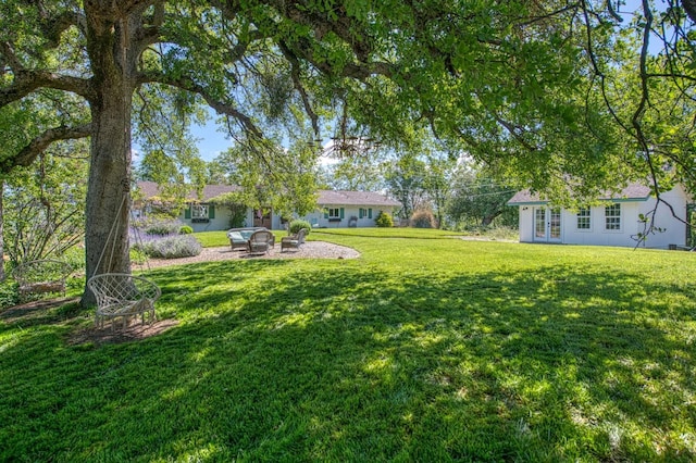 view of yard with a patio and french doors