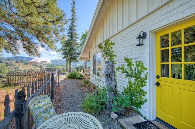 exterior space featuring board and batten siding and fence