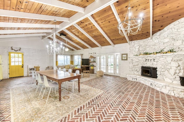 dining area featuring an inviting chandelier, wood ceiling, brick floor, french doors, and lofted ceiling with beams