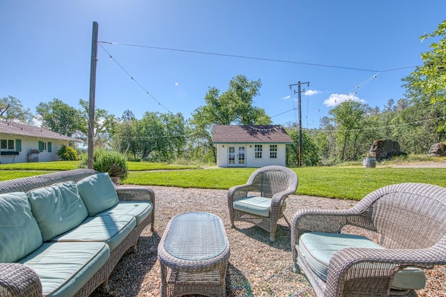 view of patio / terrace featuring outdoor lounge area, french doors, and an outbuilding