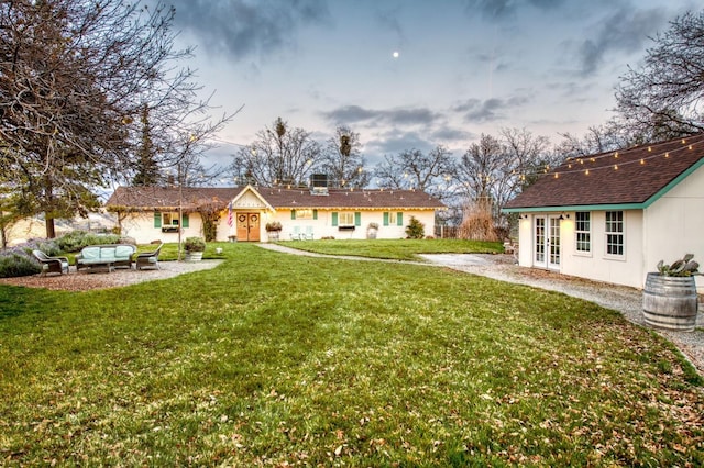 yard at dusk with an outdoor hangout area