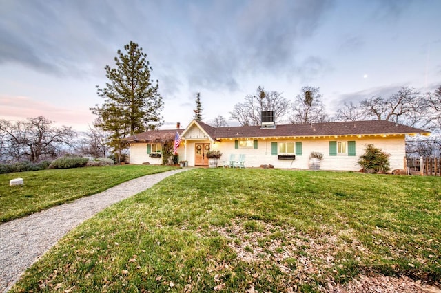 ranch-style house with a lawn