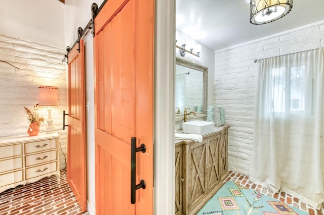 bathroom with vanity, brick floor, and brick wall