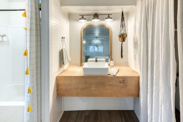 full bathroom featuring shower / bath combo with shower curtain, wood finished floors, and vanity