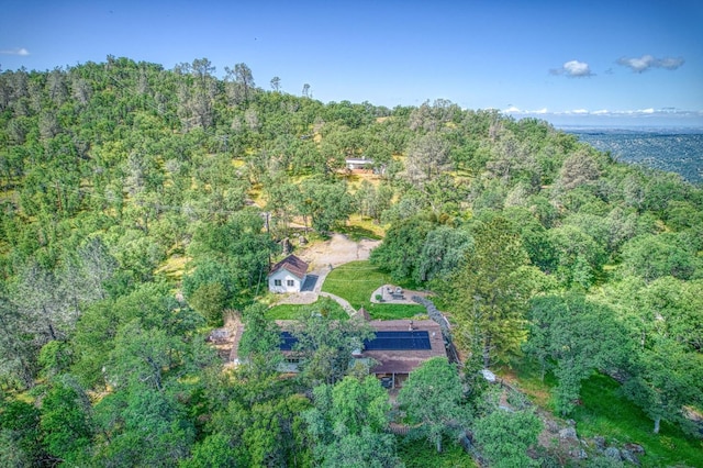 drone / aerial view featuring a wooded view