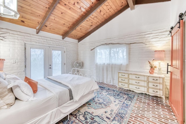 bedroom featuring beam ceiling, access to exterior, a barn door, brick floor, and french doors