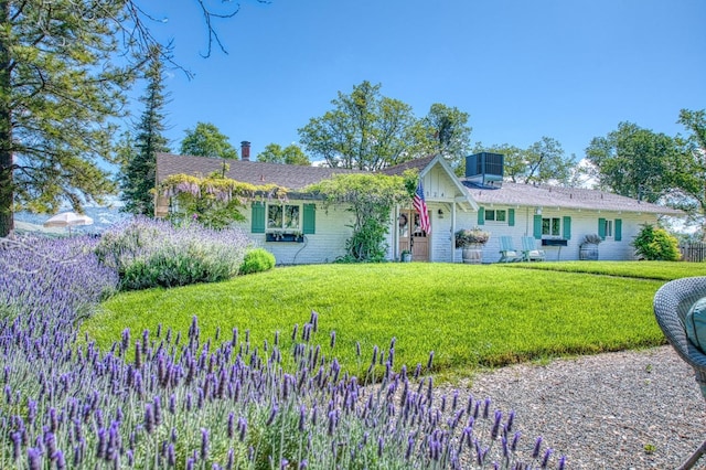 single story home with a front lawn, board and batten siding, and cooling unit