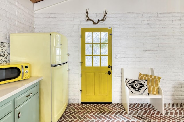 doorway to outside with brick floor