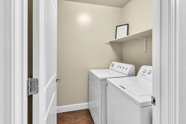 washroom featuring washing machine and dryer and dark wood-type flooring