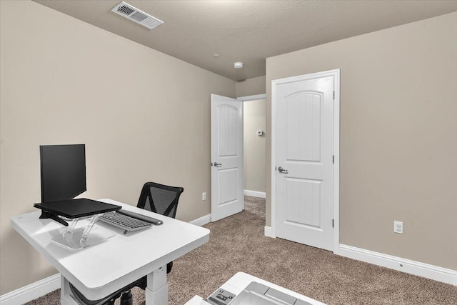 office space featuring carpet and a textured ceiling