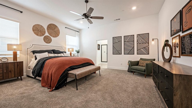 carpeted bedroom featuring visible vents, a ceiling fan, connected bathroom, and baseboards