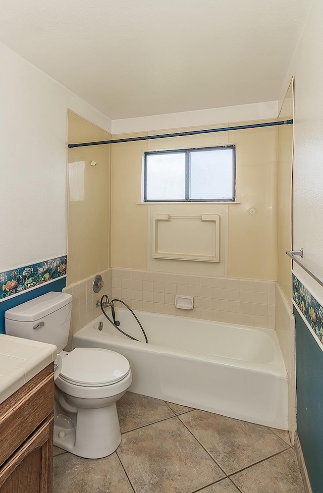 bathroom with tile patterned floors, vanity, toilet, and a bathtub