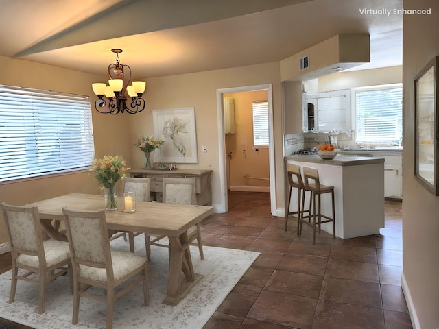 1855 Dennis Ave, Clovis, CA 93611 - dining area with dark tile patterned flooring, visible vents, a notable chandelier, and baseboards