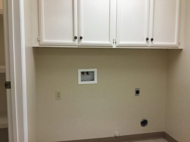 laundry room featuring cabinets, hookup for a washing machine, and hookup for an electric dryer