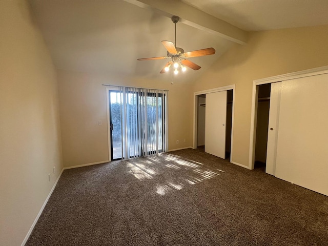 unfurnished bedroom featuring ceiling fan, dark carpet, lofted ceiling with beams, and multiple closets