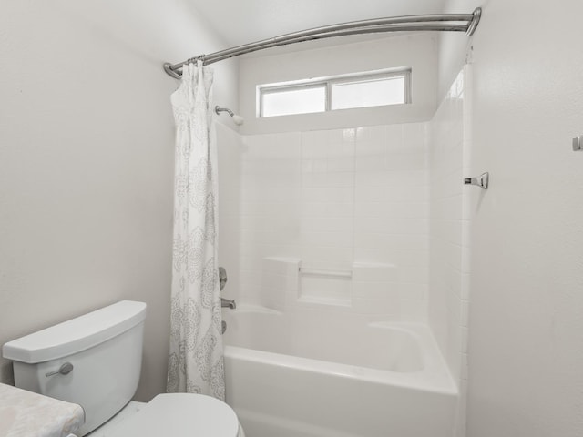 bathroom featuring shower / bathtub combination with curtain and toilet