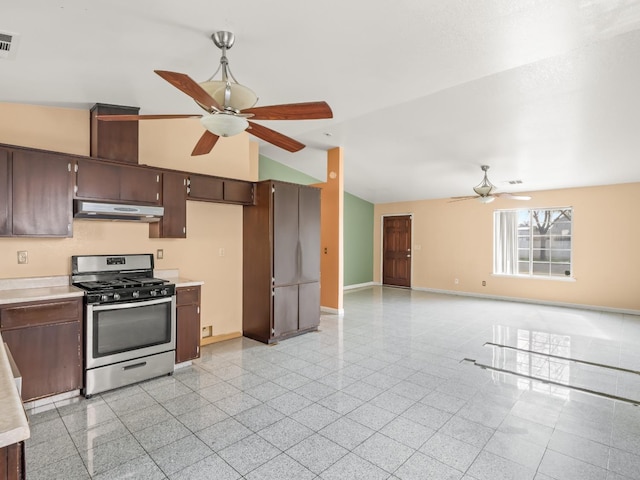 kitchen with ceiling fan, lofted ceiling, stainless steel gas range, and dark brown cabinetry