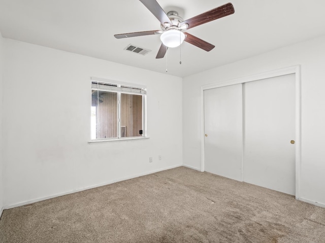 unfurnished bedroom featuring ceiling fan, carpet flooring, and a closet