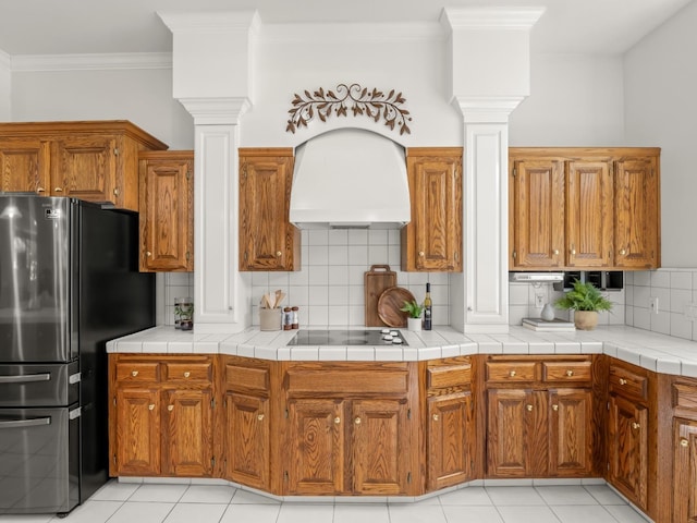 6702 N Langley Ave, Clovis, CA 93619 - kitchen featuring premium range hood, freestanding refrigerator, black electric cooktop, and decorative columns