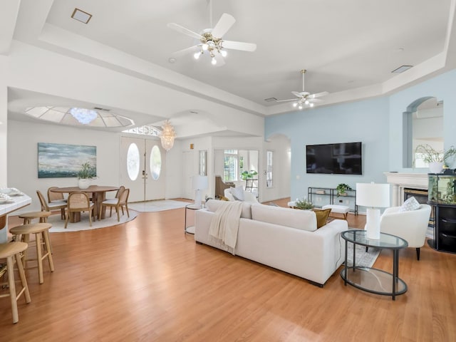 6702 N Langley Ave, Clovis, CA 93619 - living room featuring a raised ceiling, light wood-type flooring, a ceiling fan, and visible vents