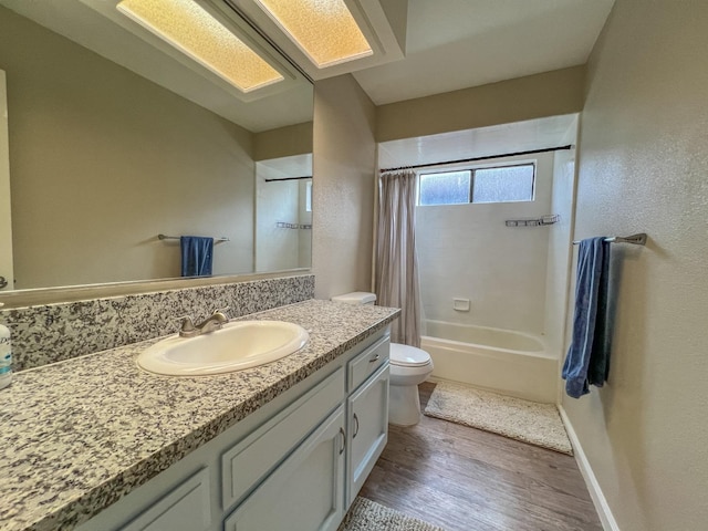 full bathroom featuring vanity, wood-type flooring, toilet, and shower / bathtub combination with curtain